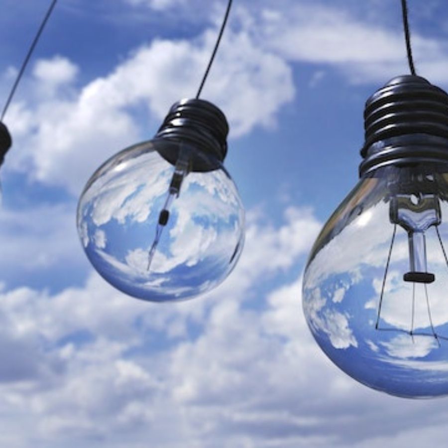 solar energy bulbs against a cloudy blue sky